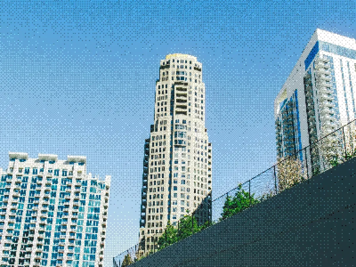 High-rise buildings viewed from a low angle against a blue sky