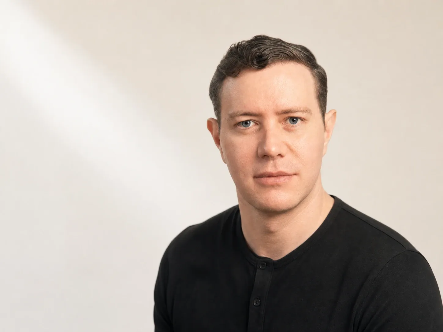Editorial portrait of Ethan Smith, CEO of Graphite, against a soft cream backdrop. The operator whose AEO playbook this post distills.